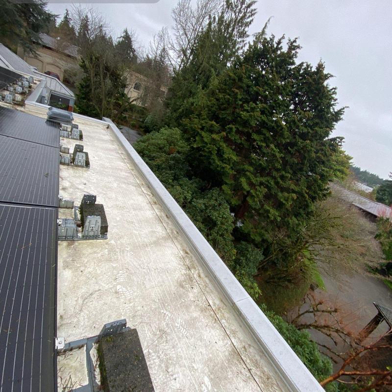 Flat roof and solar panel cleaning with gutter clearing