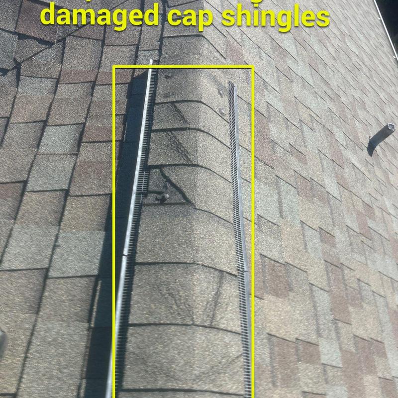 Roof ridge cap shingles with visible damage Roof ridge cap shingles with visible damage