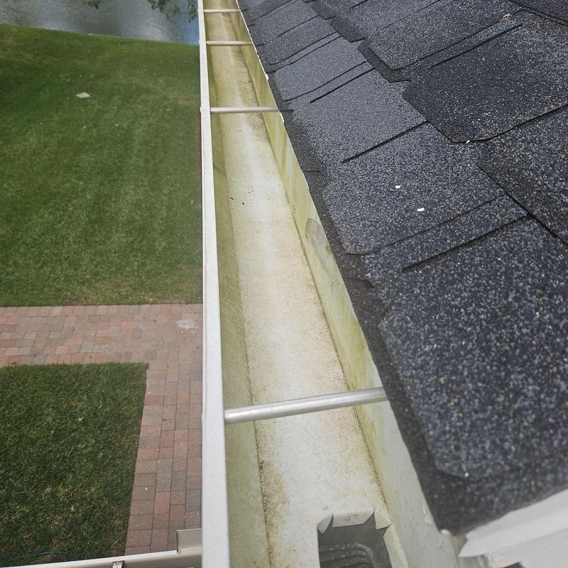 Gutter with metal guards and clean debris removal Gutter with metal guards and clean debris removal