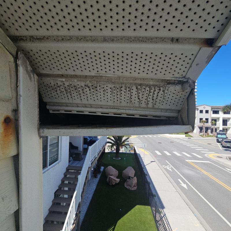Soffit panels with rust and grime buildup outdoors Soffit panels with rust and grime buildup outdoors