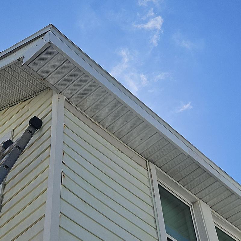 Soffit panels on house exterior north side under blue sky Soffit panels on house exterior north side under blue sky