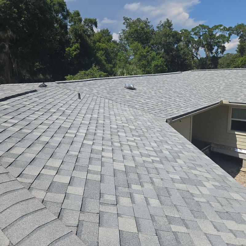 Asphalt shingle roof installation on residential house Asphalt shingle roof installation on residential house