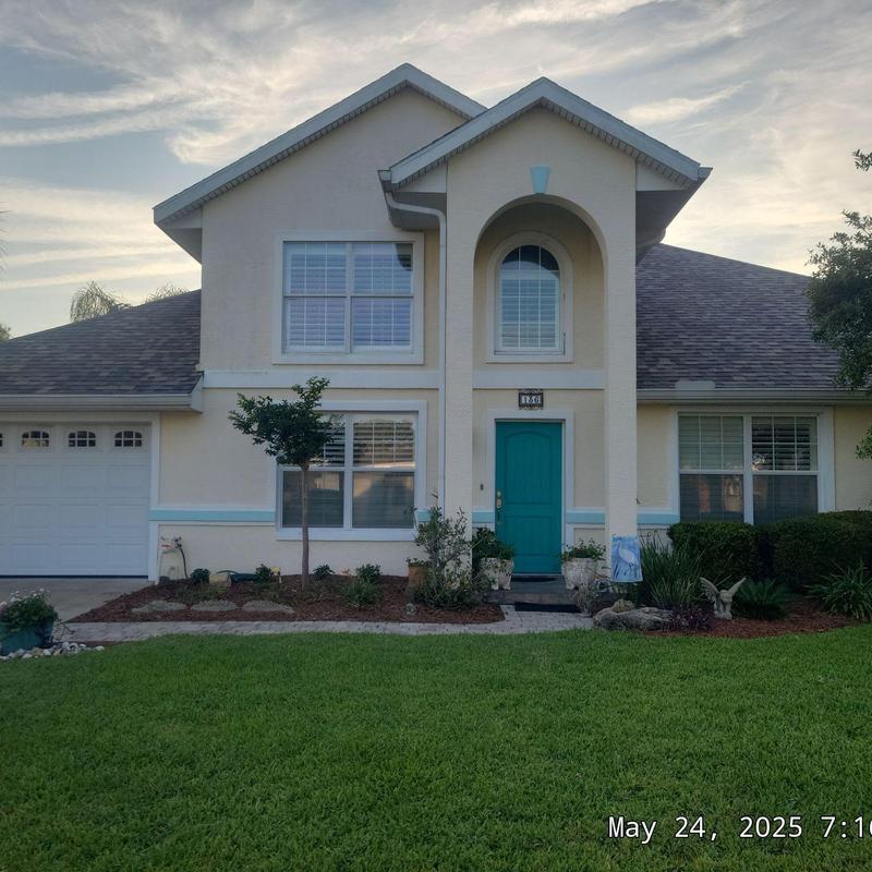 Asphalt shingle roof on two-story house with landscaping Asphalt shingle roof on two-story house with landscaping