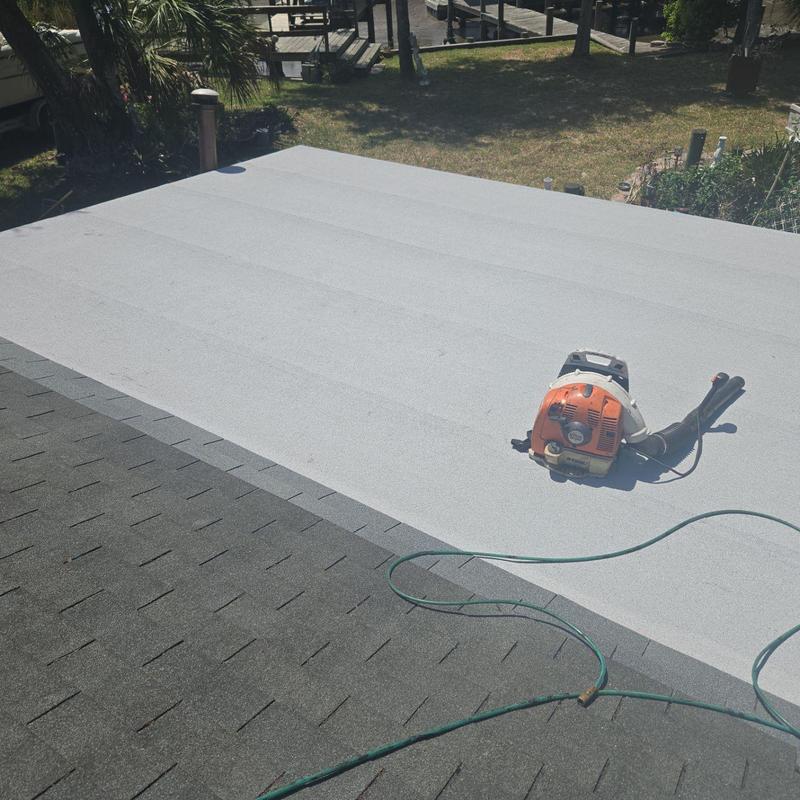 Low slope roof with blower and garden hose Low slope roof with blower and garden hose