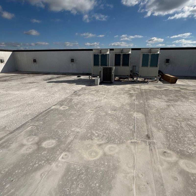 Roof membrane with hail impact marks and rooftop units