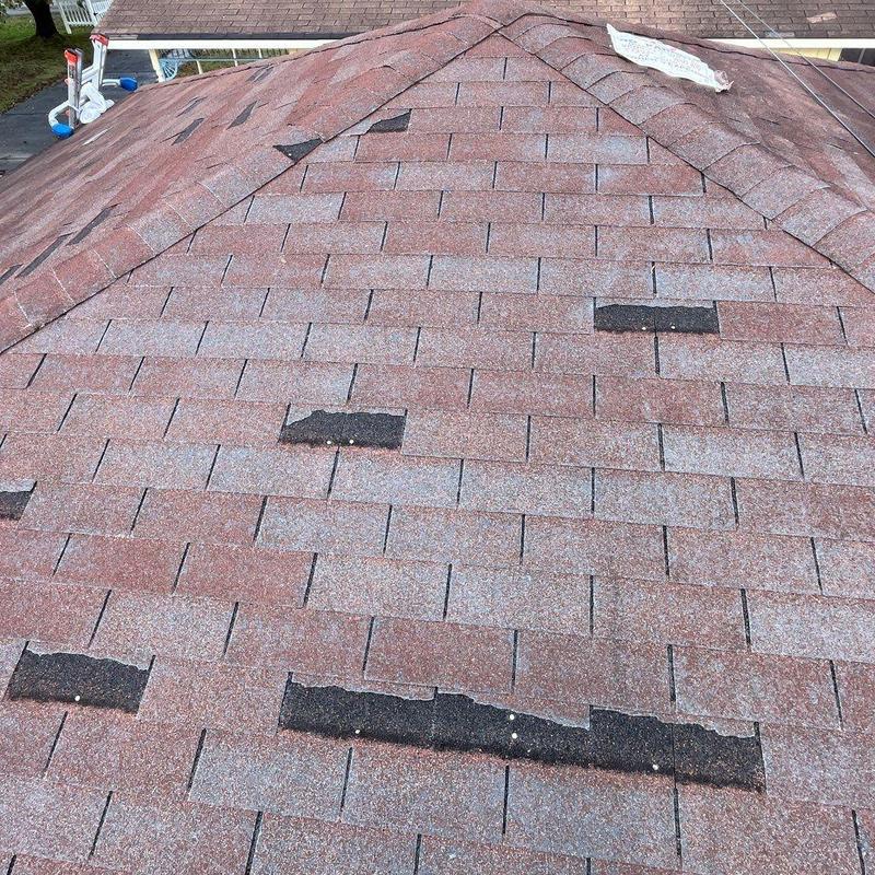 Asphalt shingle roof with hail damage and missing granules