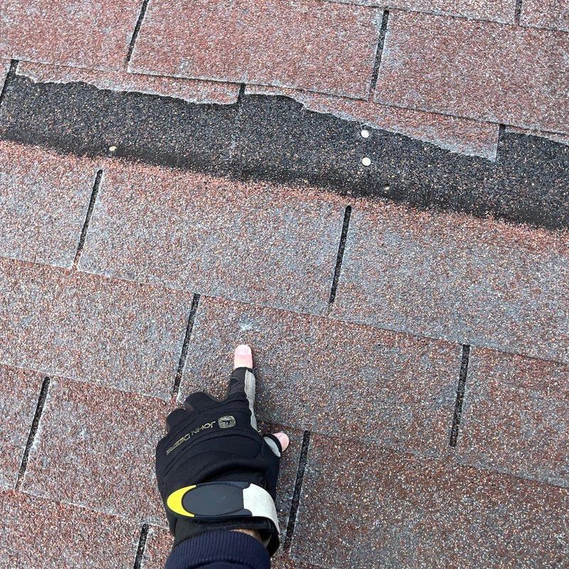 Asphalt shingle damage from hail impact on roof surface