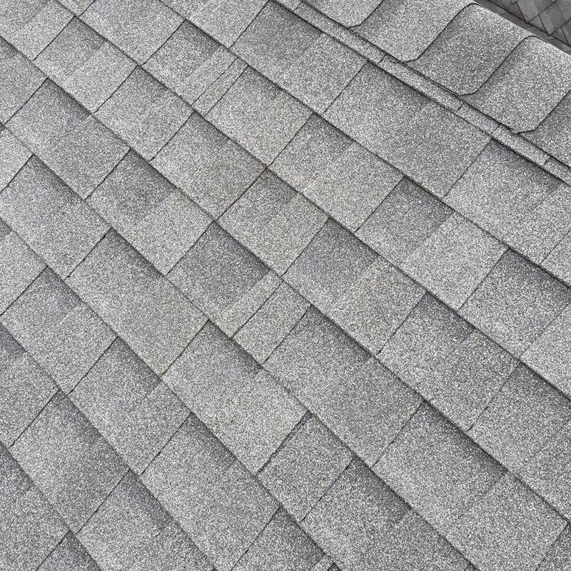 Asphalt shingle roof with hail damage close-up