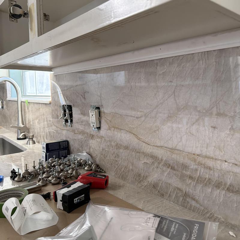 Kitchen cabinet trim with tools and hardware on counter Kitchen cabinet trim with tools and hardware on counter