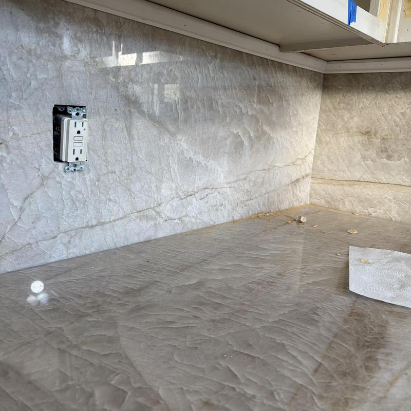 Marble countertop and backsplash with outlet installation Marble countertop and backsplash with outlet installation