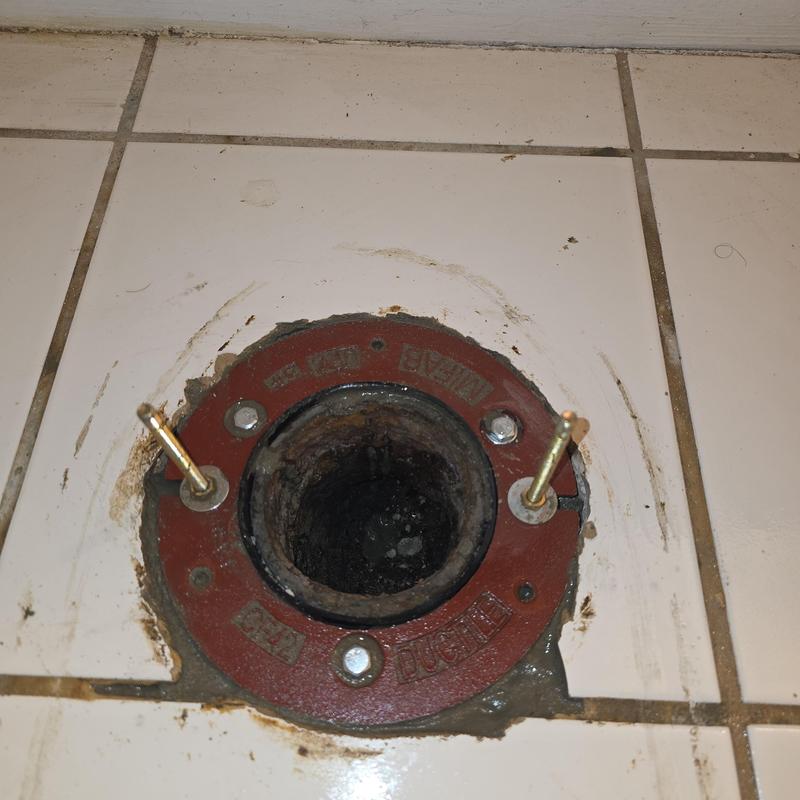 Cast iron toilet flange installed in tiled floor