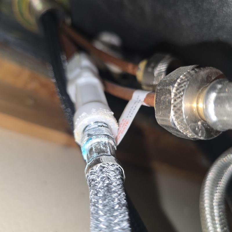 Kitchen faucet water supply line connection close-up