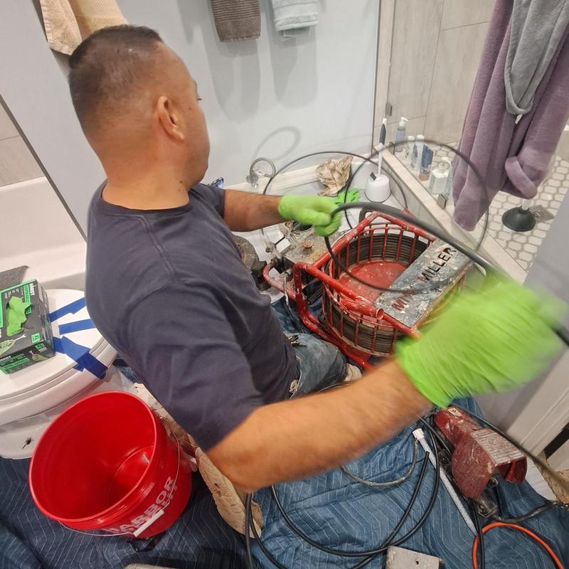 Toilet drain line cleaning with cable machine Toilet drain line cleaning with cable machine