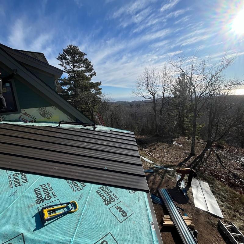 Standing seam steel roofing installation with underlayment Standing seam steel roofing installation with underlayment