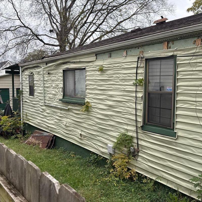Vinyl siding warped and buckled on house exterior