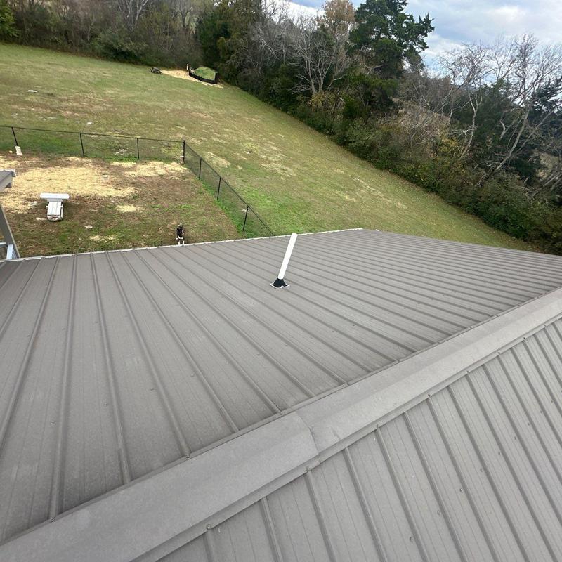 Metal roof panels with vent pipe flashing seal