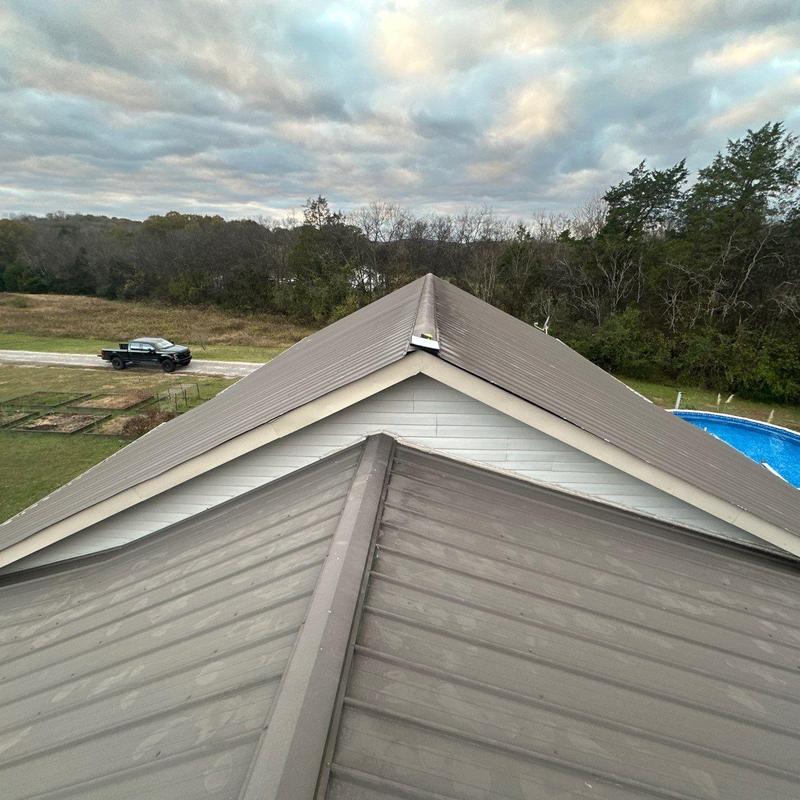 Metal roof ridge and panel inspection with hail damage