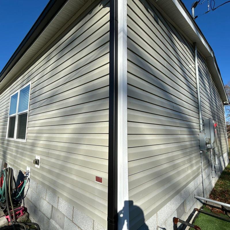 Vinyl siding exterior corner with downspout and utilities