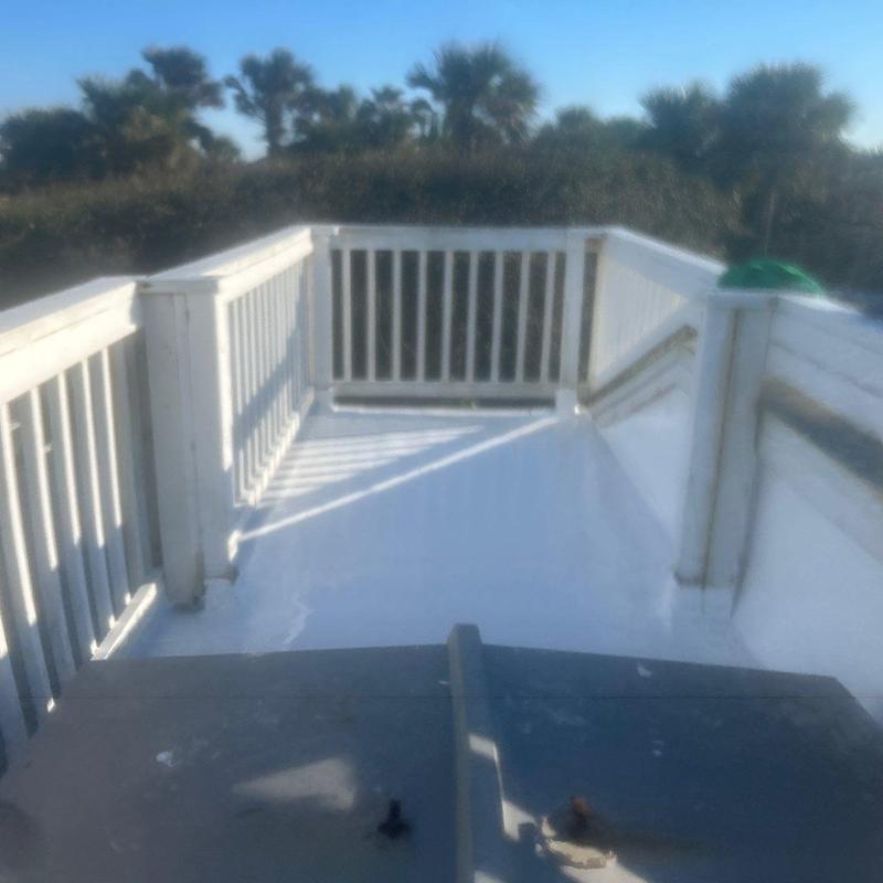 Silicone roofing coating on rooftop deck surface Silicone roofing coating on rooftop deck surface