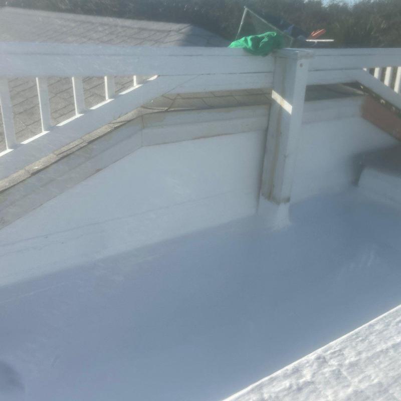 Silicone roofing membrane installed over rolled roof Silicone roofing membrane installed over rolled roof