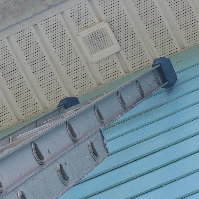 Bathroom vent on soffit with ladder against house wall Bathroom vent on soffit with ladder against house wall