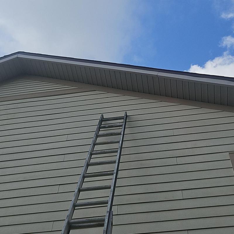Fascia cladding with ladder against house exterior Fascia cladding with ladder against house exterior