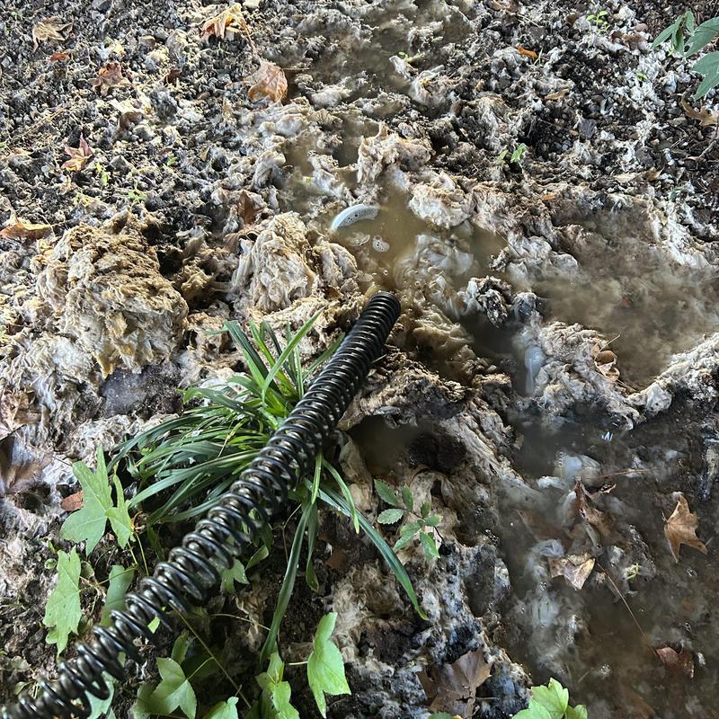Mainline sewer blockage with water and debris in soil