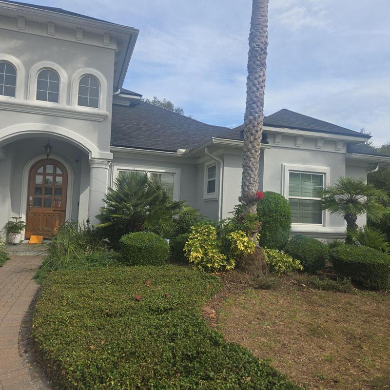 Asphalt shingle roof on residential home with landscaping Asphalt shingle roof on residential home with landscaping