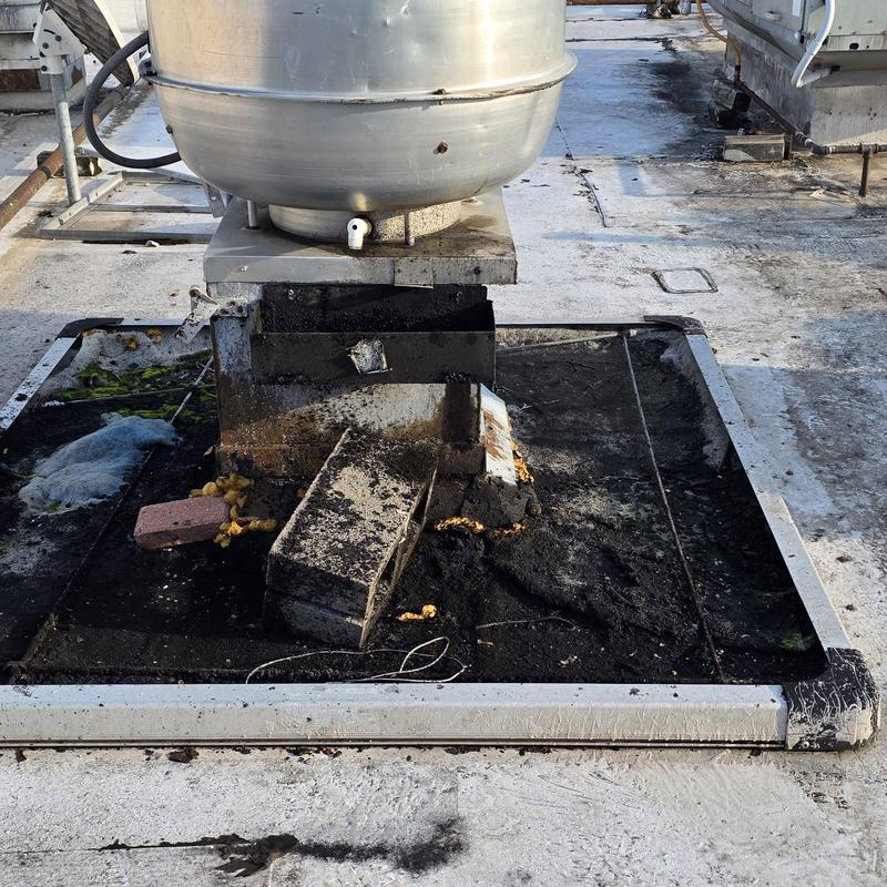 Rooftop HVAC unit base with debris and damage Rooftop HVAC unit base with debris and damage