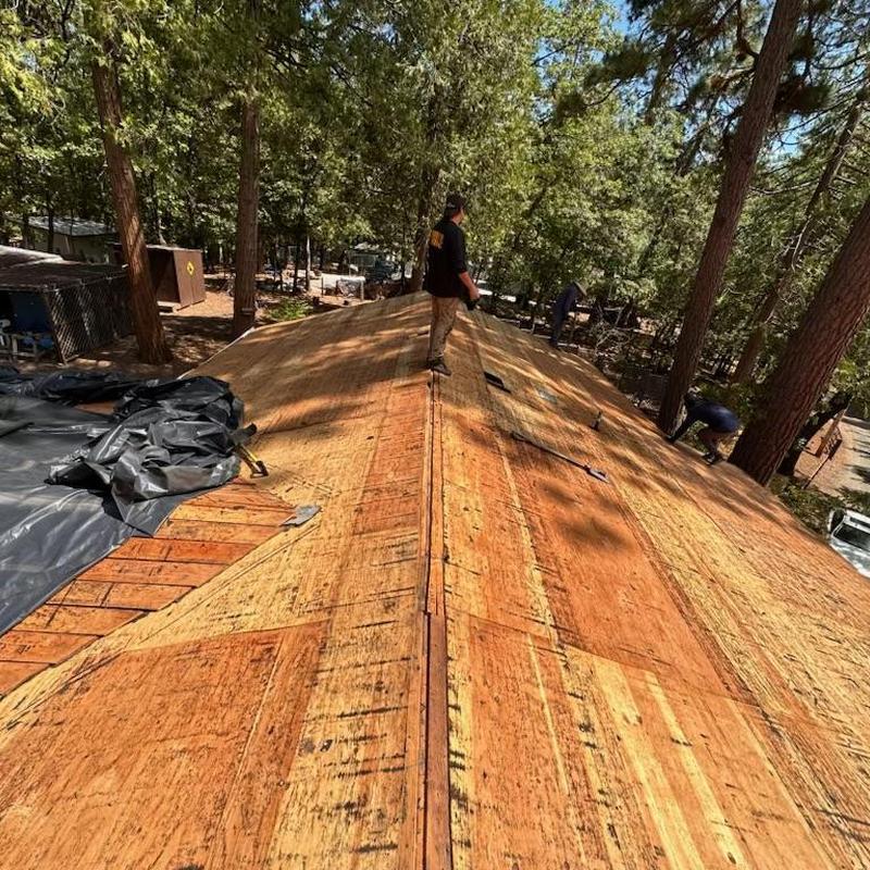 Plywood roof decking installation on residential roof