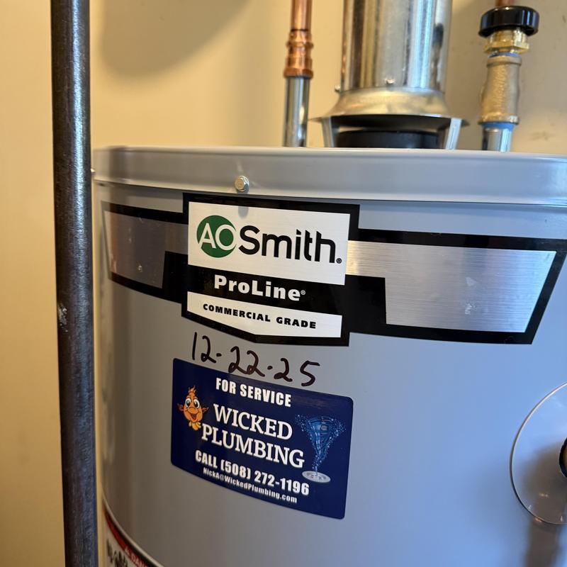 Water heater with plumbing service label in Fall River MA