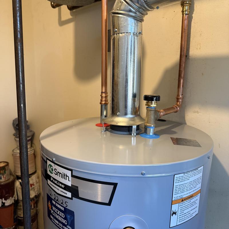 Water heater with vent pipe and copper plumbing connections