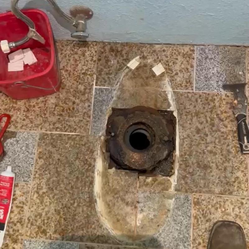 Toilet flange and wax ring replacement area on tile floor