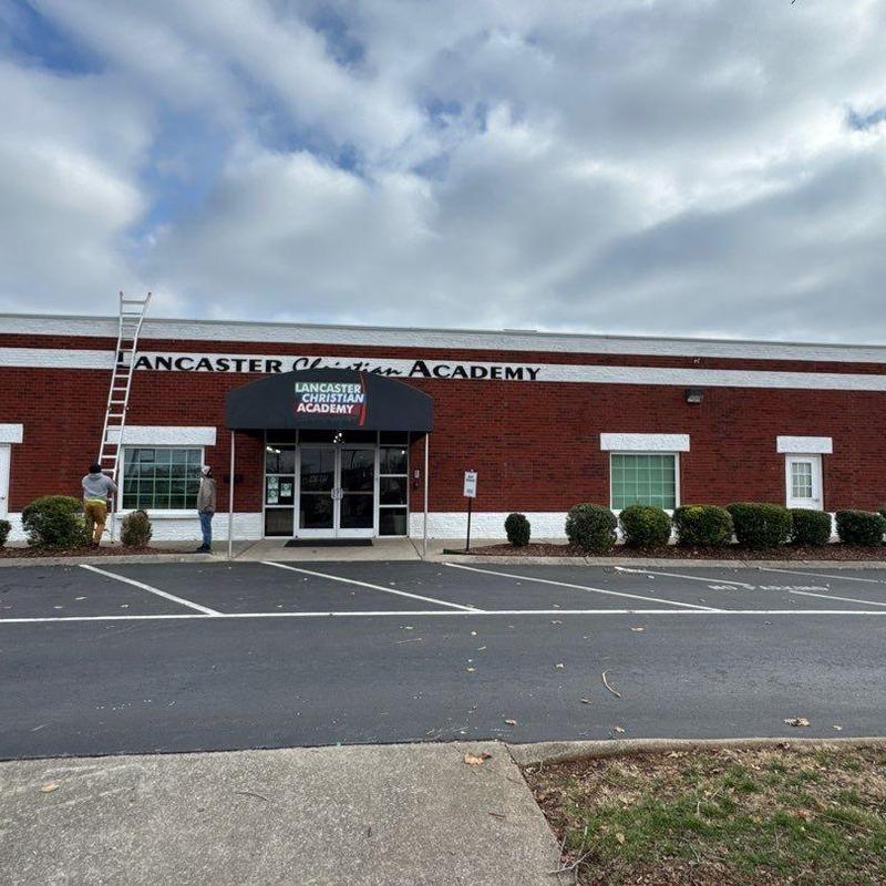 Commercial roof with inspection ladder and workers