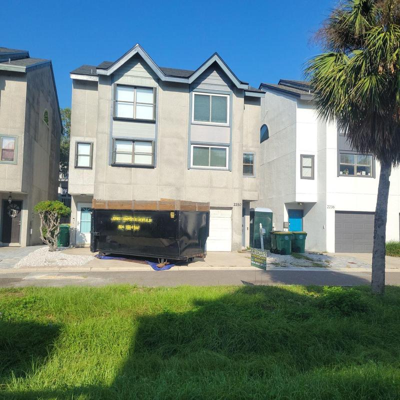Owens Corning roofing materials dumpster in driveway Owens Corning roofing materials dumpster in driveway