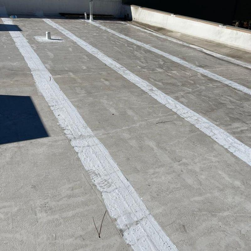 Commercial flat roof with silicone seam coating
