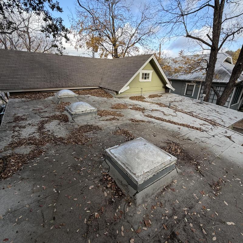 Modified bitumen flat roof with leaf debris buildup