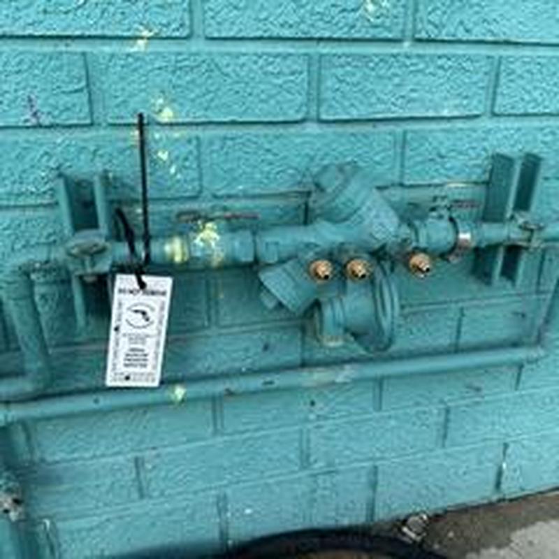 Backflow prevention device inspection with certification tag