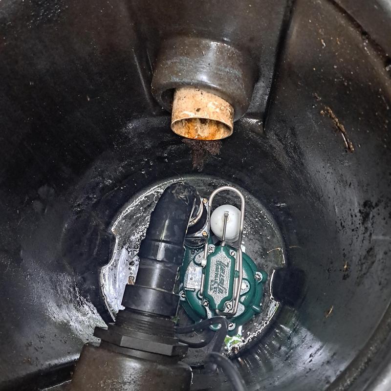 Sump pump and discharge pipe in backyard pit Sump pump and discharge pipe in backyard pit