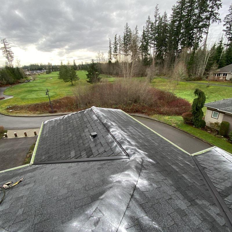Asphalt shingle roof with ridge vent on cloudy day