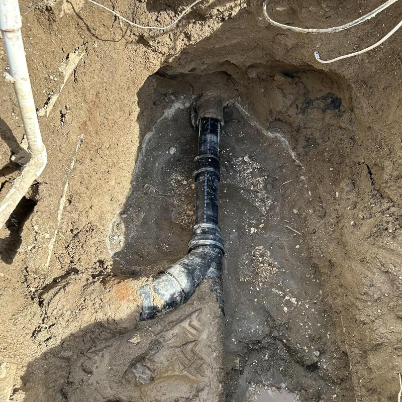 Broken drain pipe excavation and replacement in soil hole