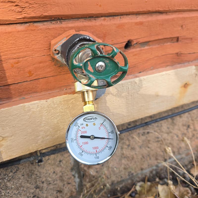 Water pressure gauge attached to outdoor valve