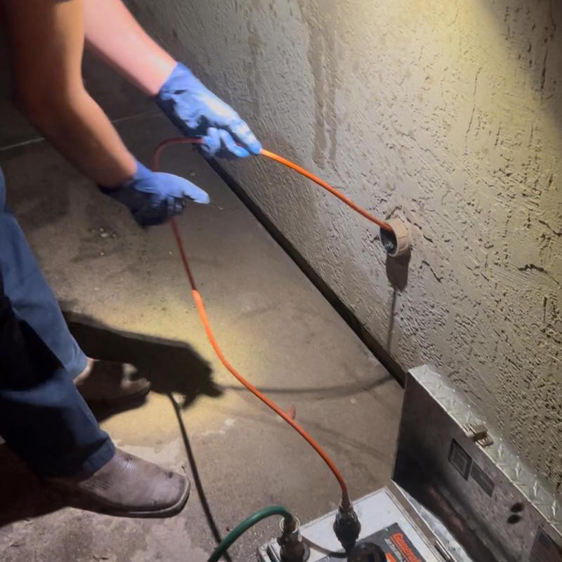 Kitchen drain hydro jetting with snake tool in wall cleanout