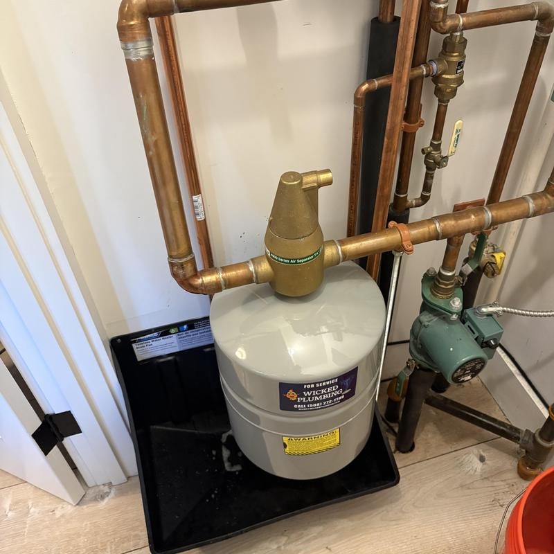 Expansion tank with copper piping in mechanical room