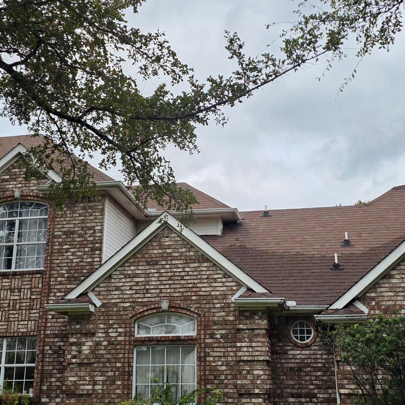 Asphalt shingle roof hail damage inspection on brick house