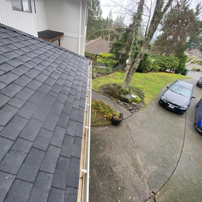 Gutter system with cleared debris on residential roof