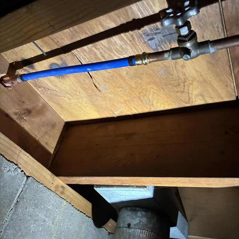 Blue PEX water supply line with shutoff valve inside wall
