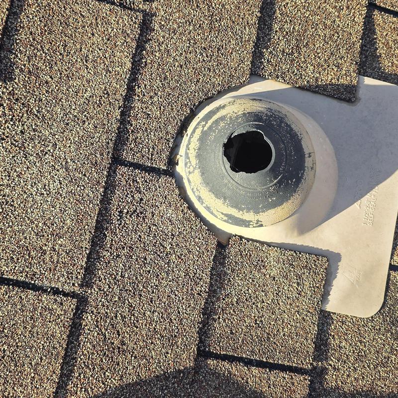 Roof vent pipe flashing with missing seal on shingle roof