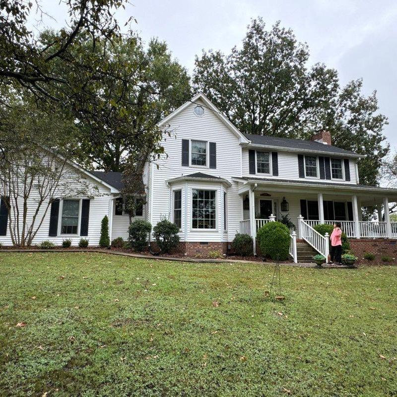 Roof shingles hail damage inspection on two-story house