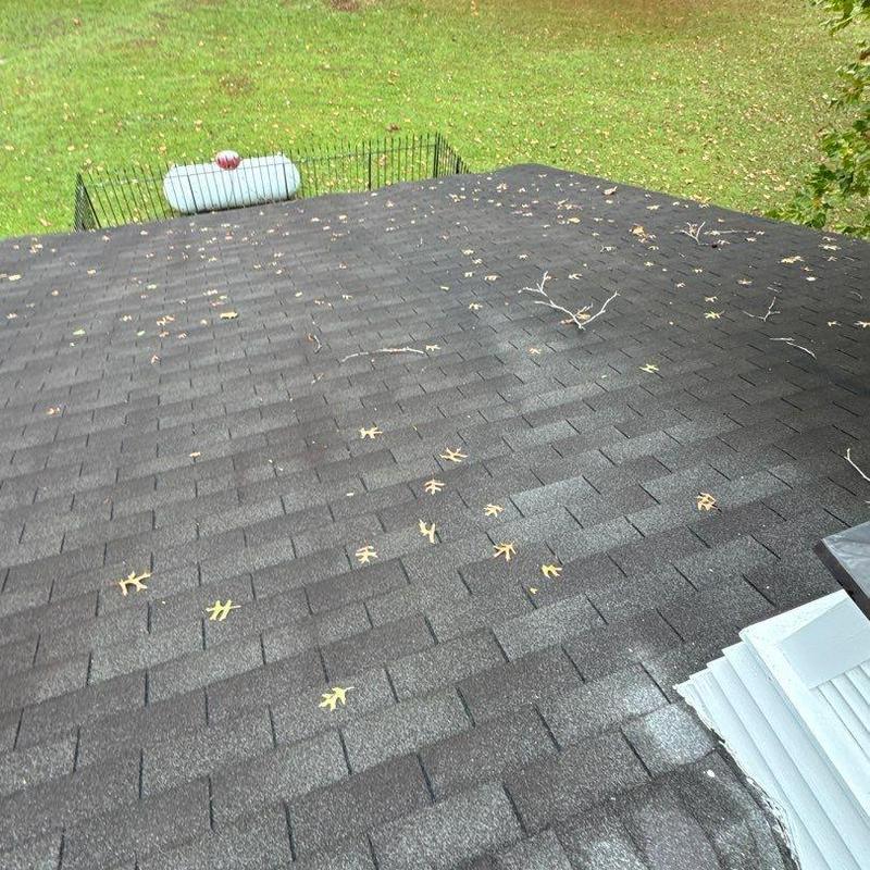 Asphalt shingle roof with hail damage and debris